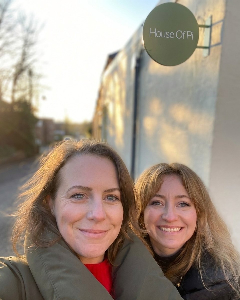 Kat and Jessie by the House of Pi sign